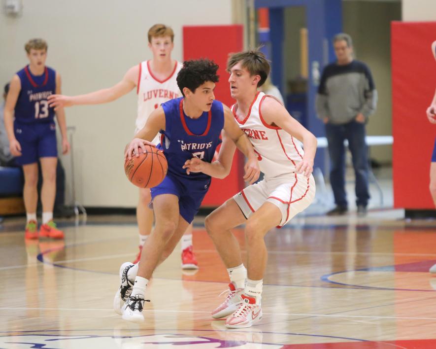 Luverne and Hills-Beaver Creek go head-to-head Monday. Feb. 5, in Hills.H-BC sophomore EJ Wegener, in blue, tries to drive past LHS junior Carter Sehr in the game. The Cardinals beat the Patriots 63-59 in a tight physical game.