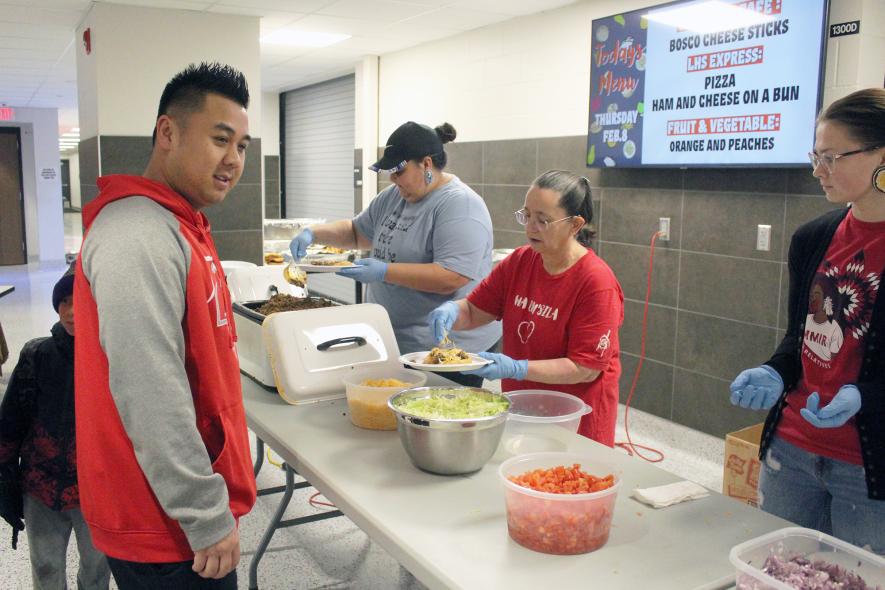 CJ Xaisongkham chooses toppings for his fry bread at the American Indian Parent Advisory Committee fundraiser Friday night in the Luverne Middle-High School commons. The committee hosted the fundraiser to begin a scholarship for American Indian students who graduate from Luverne. Serving the fry bread are (from left) Destiny Ripka, Mary Johnson and Justyce Gartner. Mavis Fodness/Rock County Star Herald Photo