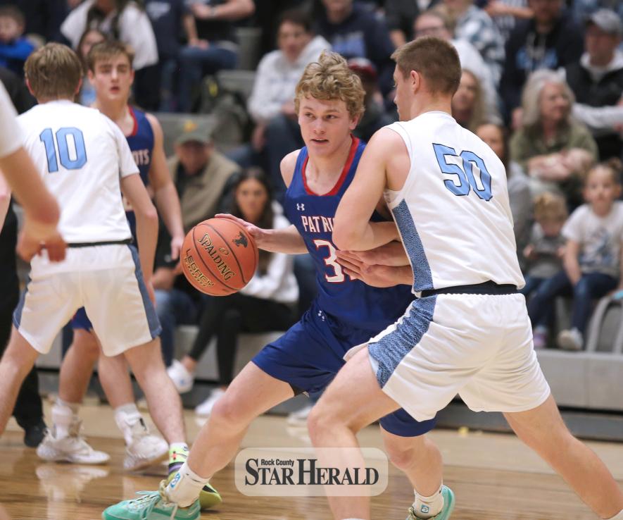 Rock Cou H-BC senior Riley Tatge dribbles through a Russell-Tyler-Ruthton defender on his way to the basket Saturday, March 9, in Marshall. The Patriots’ season ended when they fell to the Knights 64-54 in the Section 3A semifinal game.nty Star Herald Photo