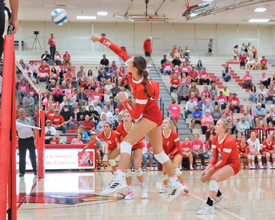 Senior Kiesli Smith spikes the ball over the net, watched by her teammates, against Pipestone Thursday, Sept. 21, at home. The Cardinals beat the Arrows three games to one for a match win.