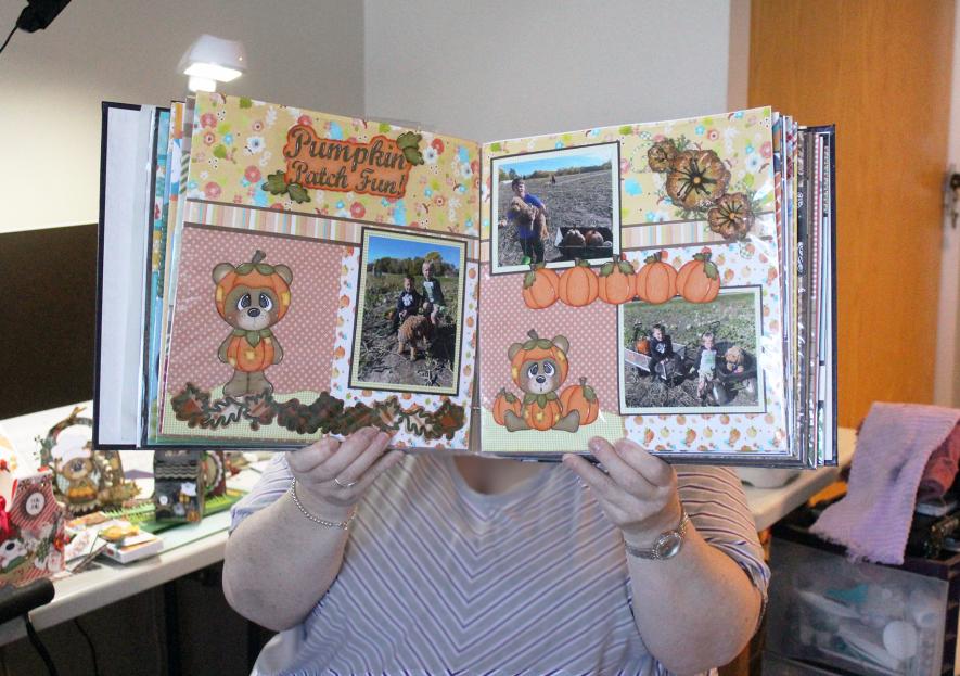 Connie Kafka of Luverne holds a scrapbook album that she is creating for a friend. She shares her "Prairie Paper Crafts" designs on Facebook, but she doesn't sell them, preferring to give them away. Mavis Fodness/Rock County Star Herald Photo