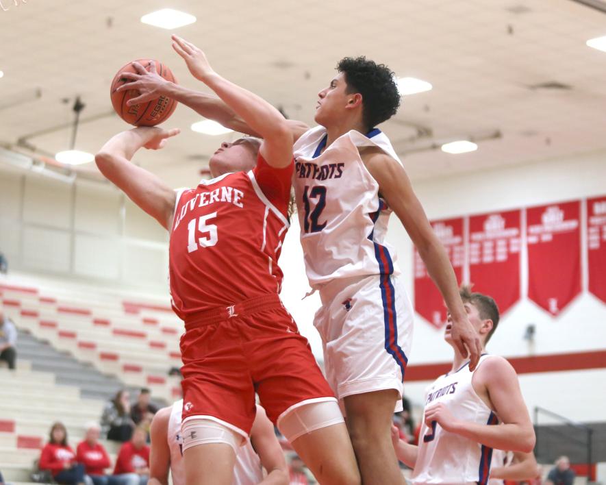 Rock LHS senior Gavin DeBeer goes up for a shot and H-BC sophomore EJ Wegener gets his hand on the ball and DeBeer for a foul Tuesday, Dec. 5. The Patriots beat the Cardinals 77-65 at home.County Star Herald Photo