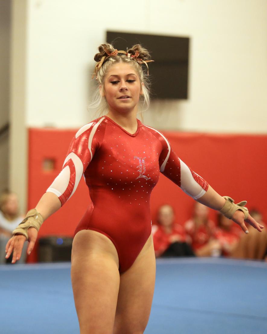 Senior Sarah de Cesare performs her final high school floor routine Tuesday, Dec. 5, at home. De Cesare decided to step aside from the sport after being hampered from the effects of a crash over a year ago. She will continue with the team, helping any way she can.
