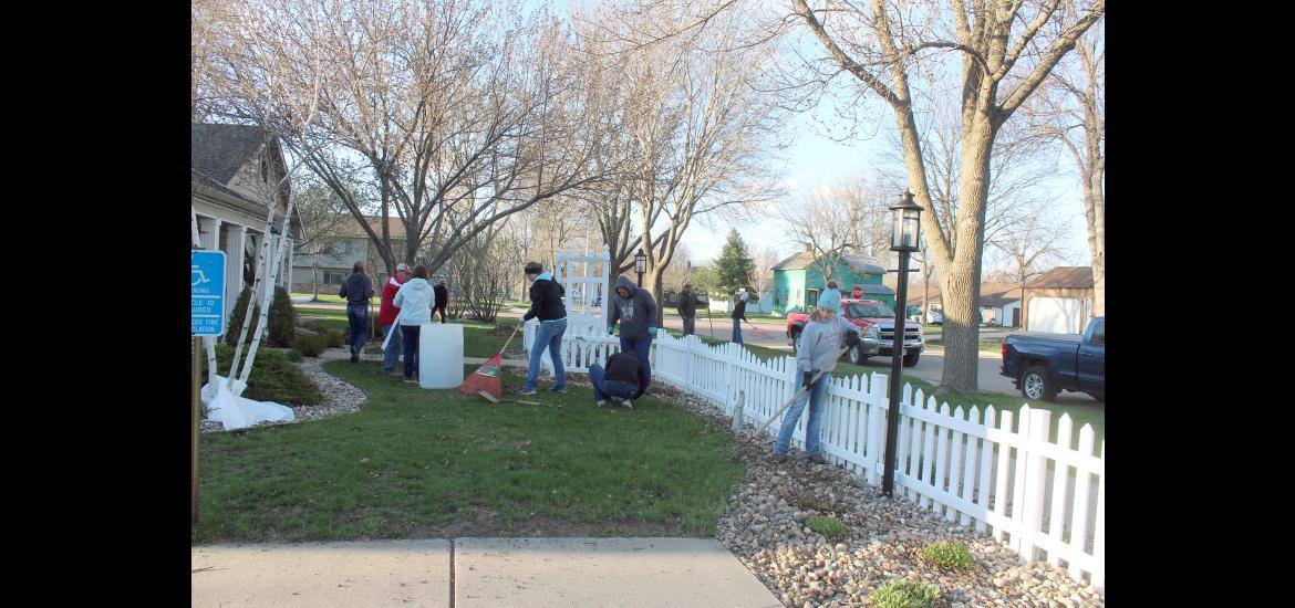 Adults and youth with the Magnolia Juniors 4-H Club gathered Thursday night, April 18, at The Cottage in Luverne where they cleaned the front and back yards. The spring landscape maintenance used to be done by George Bonnema, who died in December. Mavis Fodness/Rock County Star Herald Photo