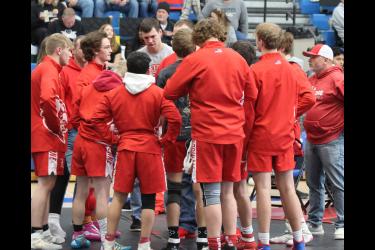 LHS coaches and wrestlers huddle before the 2024 Section 3AA section individual tournament in Windom Saturday, Feb. 24. 