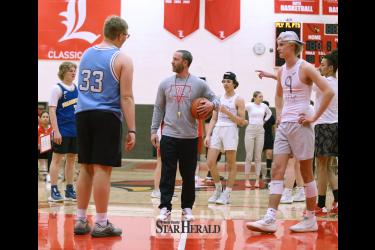 TJ Newgard (center) gets teams ready for the March Mayhem tournament  faceoff Tuesday, March 19, in the LHS Classic Gym. Several student teams competed to raise money for the Senior Student Council.