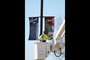 Braydon Ripka secures the new banner into place. Mavis Fodness/Rock County Star Herald Photo