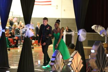 Jack Voohees escorts Gracie Runia through the high school gym. Greg Hoogeveen/Rock County Star Herald Photo