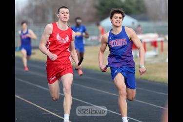LHS junior Coulter Thone (left) and H-BC sophomore Micah Bush push toward the finish line Friday, April 5, in Luverne. Bush and his 4-by-200-meter relay teammates finished in second with a time of 1:39.17. The LHS team was disqualified in the race.