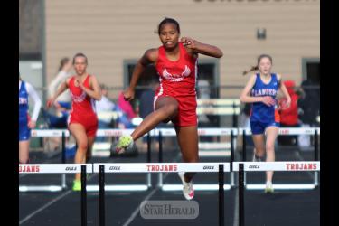 LHS freshman Reinha John hurdles her way to a first-place win in the 300-hurdles Thursday, April 25, in the Worthington track meet. She finished in a personal record time of 48.58.