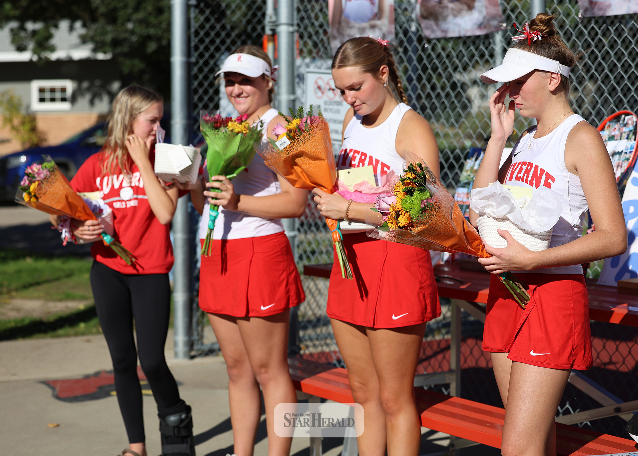 Greg Hoogeveen photo/1008LHStennis1 LHS tennis team celebrates senior night Oct. 1 in Luverne. Seniors Marlee Nelson-manager, left, Allyssa Evers, Olivia Ver Steeg and Sophia Remme receive flowers before the match with Marshall. LHS fell 6-1 to the Tigers.