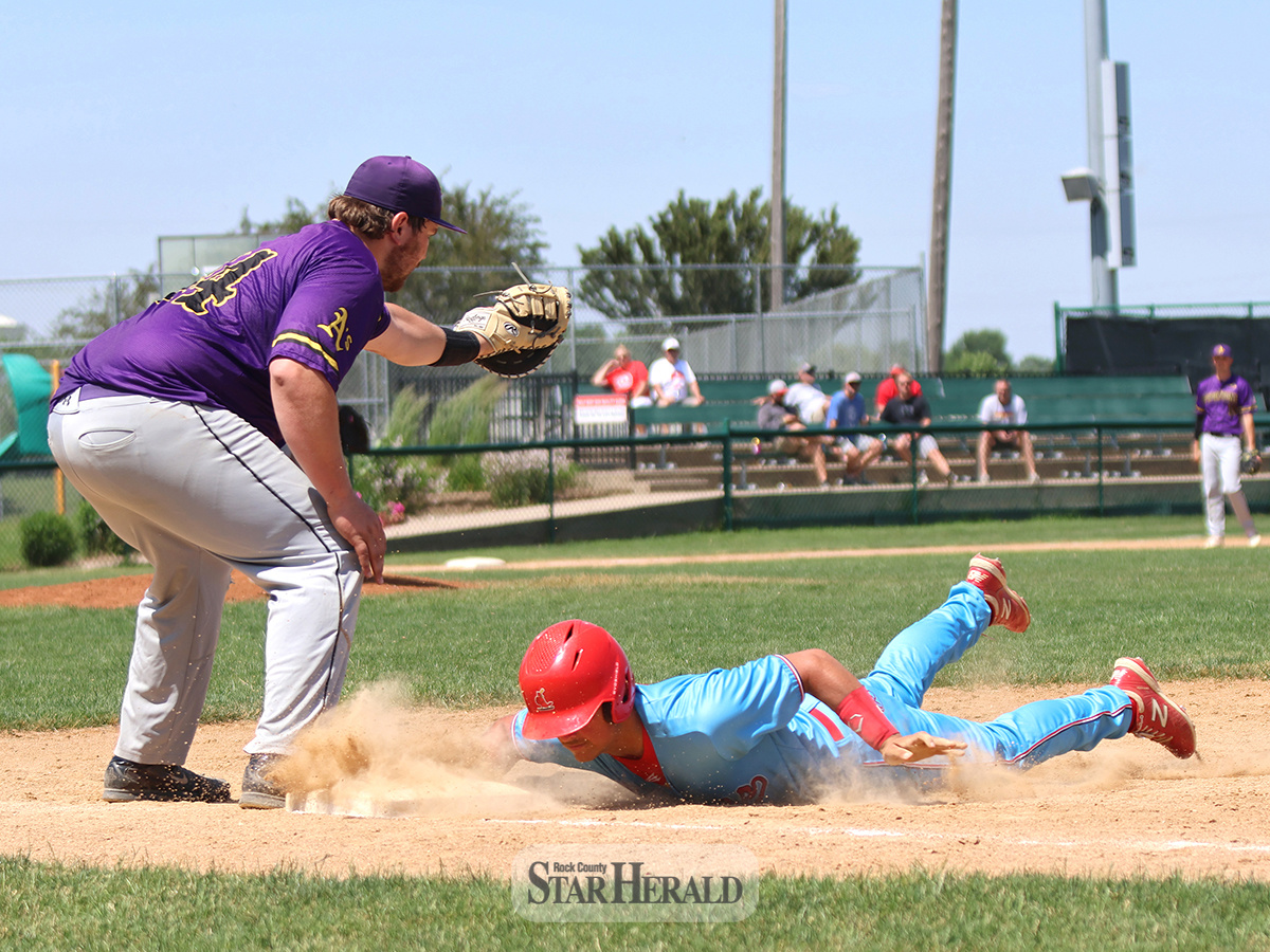 Braydon Ripka dives back into first base safely as Pipestone tries to pick him off at first. Luverne blanked Pipestone 12-0 at home Sunday, June 16.