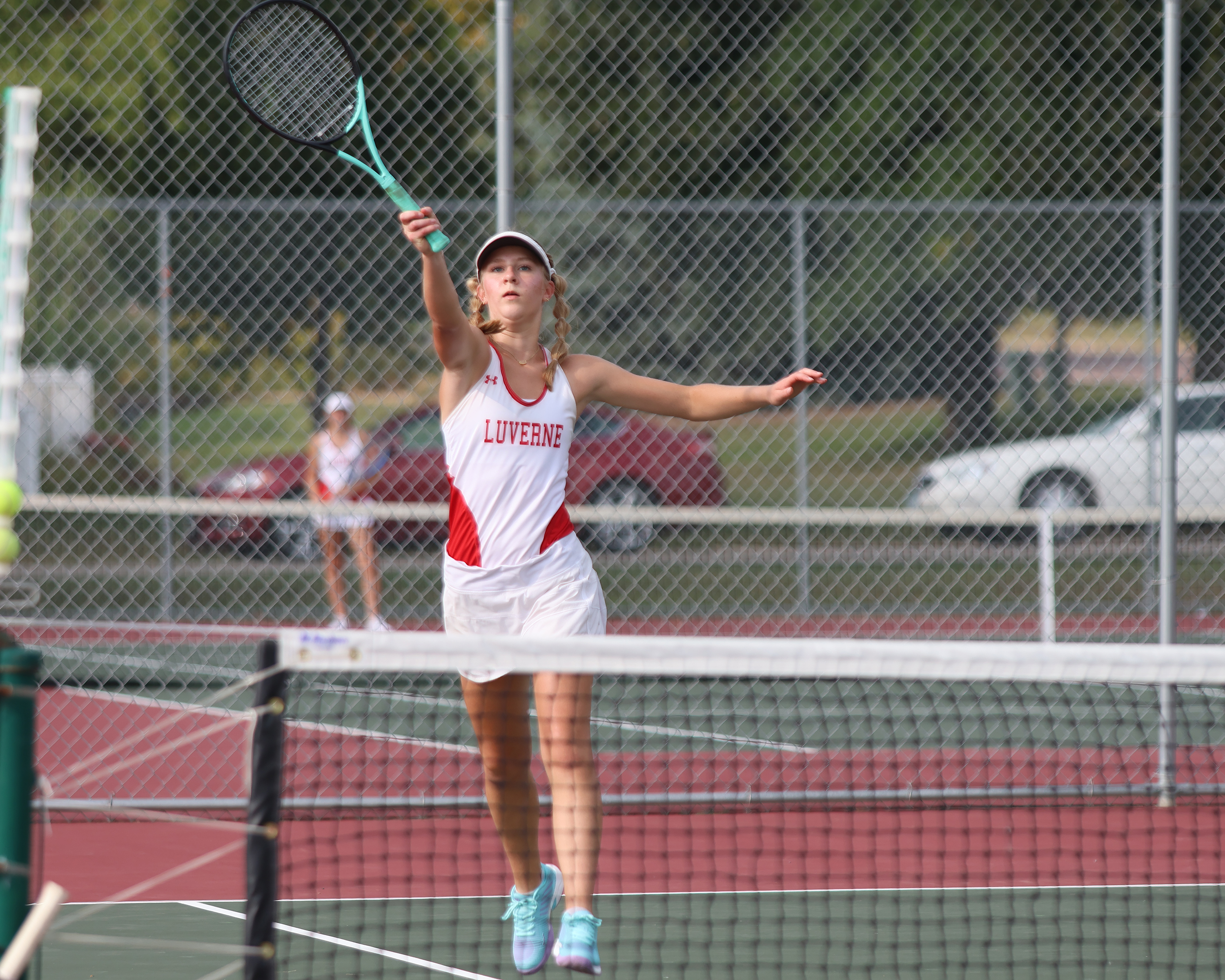 Junior Emma Nath returns a volley against her Fairmont opponent Tuesday, Aug. 29, in Luverne.