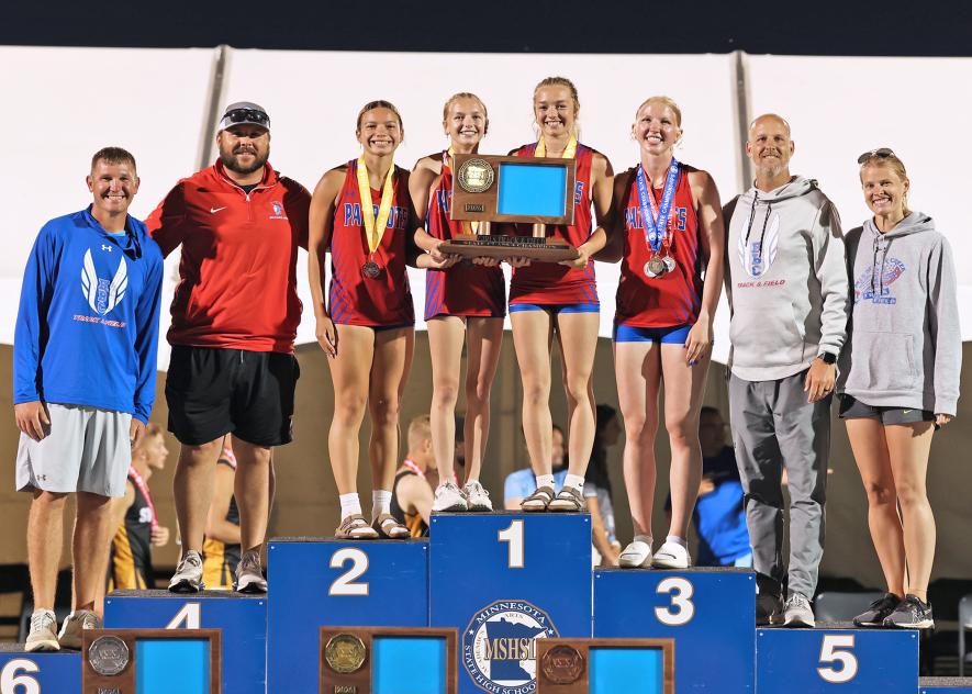 The 2026 Girls’ State Track and Field Champions include (from left) assistant coach Darin DeBoer, assistant coach Dalton Bass, Ivy Scott, Tenley Balster, Ivy Olson, Brynn Bakken, head coach Rex Metzger and assistant coach Kaylan Untiedt
