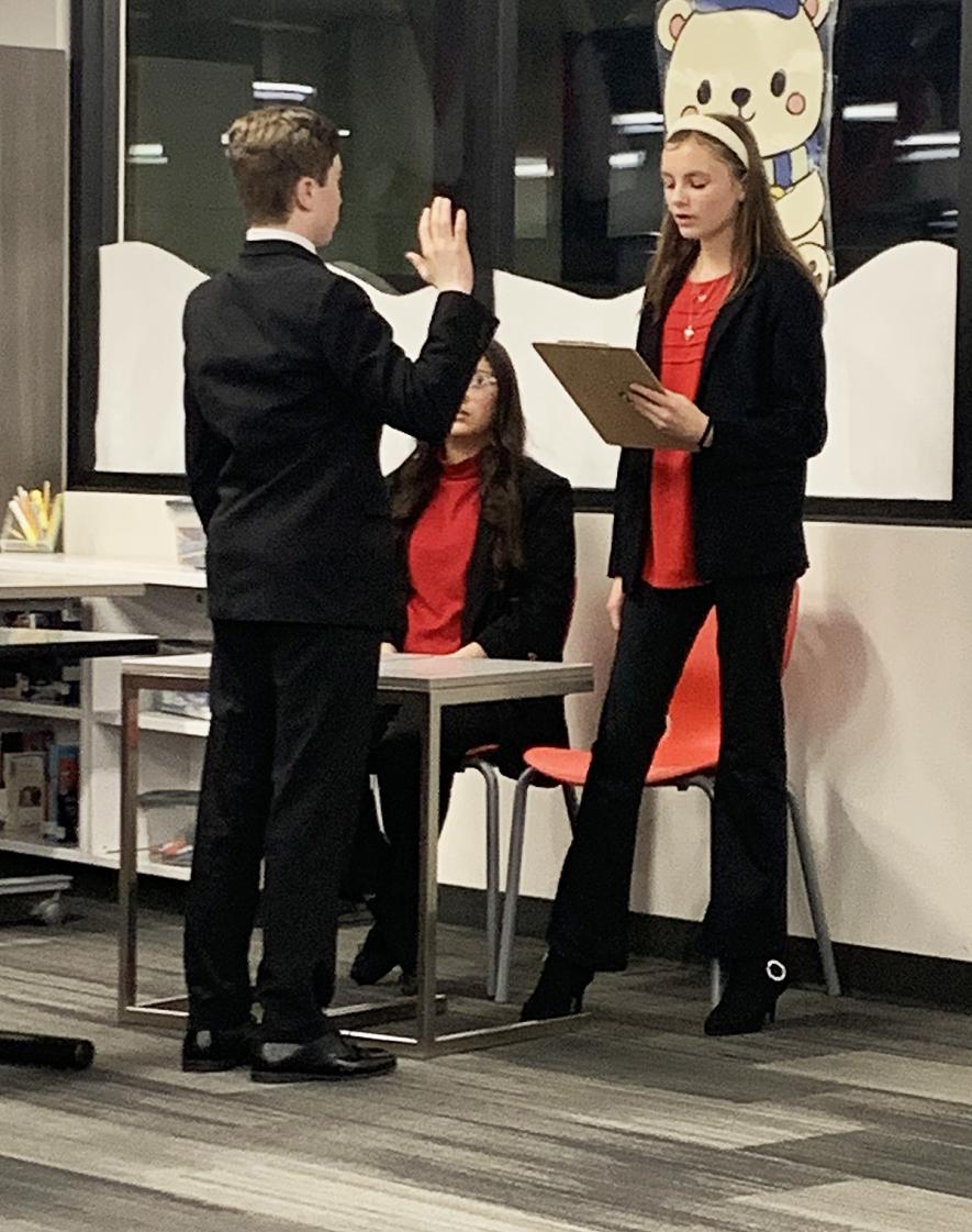 Witness Madden Von Tersch is sworn in by bailiff Molly Boltjes while bailiff Madeline Zavola Soto watches. Mavis Fodness/Rock County Star Herald Photo