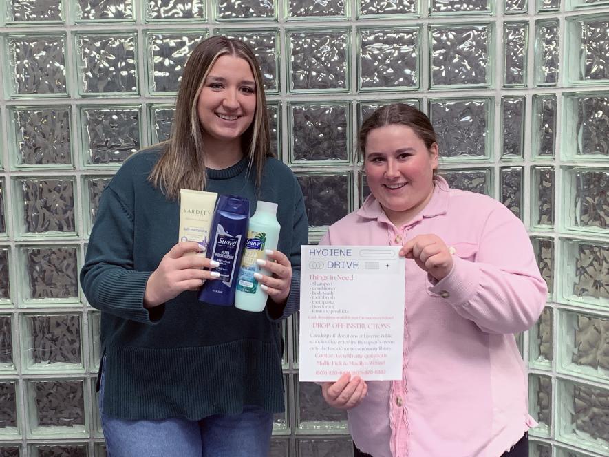 Madi Wenzel (left) holds examples of hygiene products she and her partner, Mallie Fick, need donated toward their hygiene drive. The pair is seeking 250 items to distribute through the Rock County Food Shelf. Mavis Fodness/Rock County Star Herald Photo