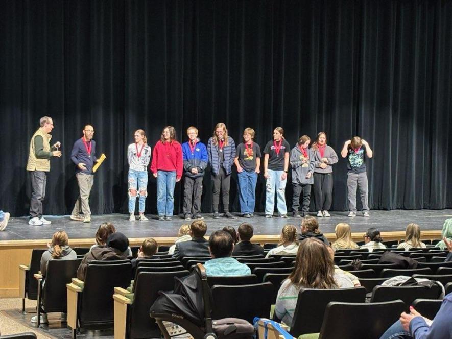 Zachary Ploeger (far left) awards second-place medals to LHS one-act play cast members (from left) director Joseph Stearns, Leigha Ehlers, Makayla Oeschle, Thomas Held, Lucas Hoffman, Natalie Berning, Rebecca Hoogland, Arlo Hogan, Paige Kubesh and Shane Travis Saturday in Pipestone. Shared image