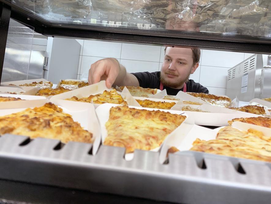Food service worker Doug Rozeboom places pizza slices in the warmer for the Luverne Middle-High School lunch hour last week. Currently the district’s food service account is carrying $31,000 in debt from overdue lunch accounts. The amount is a concern for district officials. Mavis Fodness/Rock County Star Herald Photo