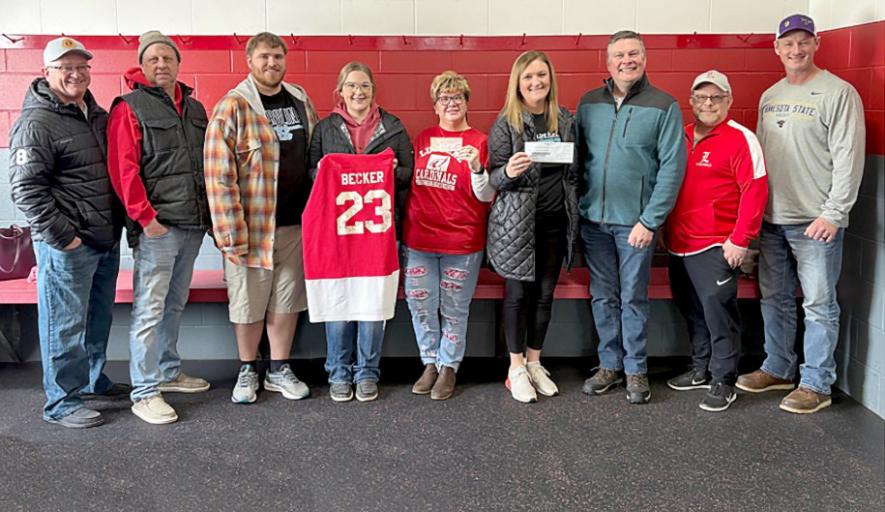 Participants in the “FIT25: Becker’s Love Health and Fitness Challenge” donated $1,200 to the Luverne Hockey Association in memory of the late Craig Becker, a 1987 LHS graduate and hockey player. On Sunday several of Becker’s classmates and hockey teammates were part of a check presentation at the Blue Mound Ice Arena. Pictured are (from left) Steve Smedsrud, Brian Arends, Josh and Syndey Benda (Becker’s son-in-law and daughter), Julie Becker (holding her husband’s LHS hockey jersey), Fitness Challenge Tash