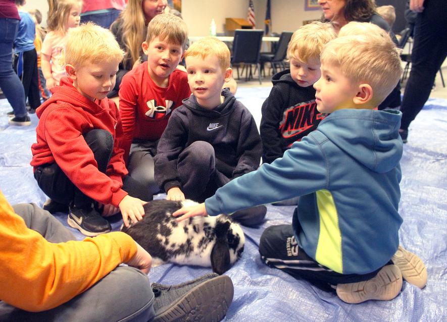 Gathering around to pet the rabbit are (from left) Sylas Frahm, Sawyer Richters, Myles Maurer, Ty Frahm and Levi Schneekloth.