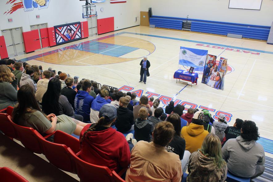 Marla Meyer, Hills-Beaver Creek Class of 1988, speaks to current secondary students March 27 in the secondary gymnasium in Hills. Meyer took students on her journey from attending H-BC to working for Coca-Cola, Pepsi and the Girl Scouts. Mavis Fodness/Rock County Star Herald Photo