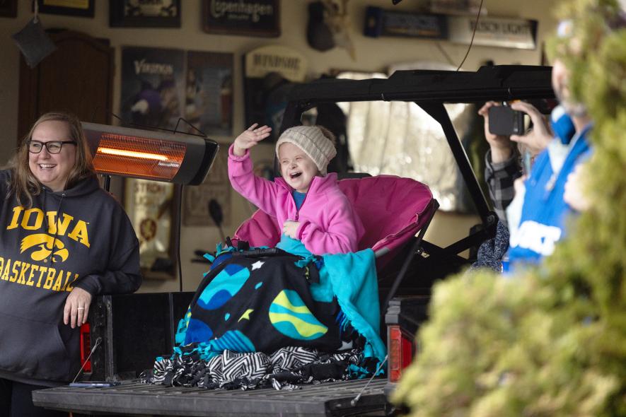 Sophie Gehrke (right, with her mother, Melissa) waves to community members and schoolmates Thursday night, April 24, during a welcome home parade past her Hills home. Sophie, a student at Hills-Beaver Creek Secondary School, underwent open heart surgery April 10, returning home after the successful operation April 23. Samantha McGaffee/Rock County Star Herald Photo