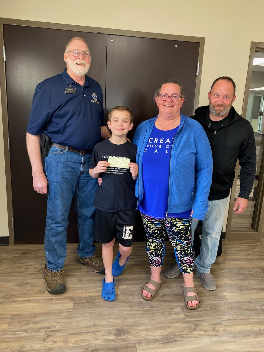 Pictured are Lions Club member Gordon Mulder (left) and Nick, Janelle and Jason Lenz. Submitted Photo