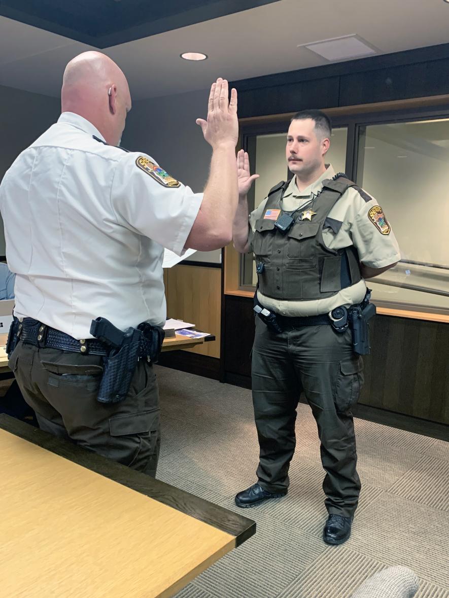Sheriff Evan Verbrugge (left) administers the oath of office to Rock County’s newest deputy Mike Haburn Tuesday morning, May 7, during the Rock County Board meeting. Mavis Fodness/Rock County Star Herald Photo