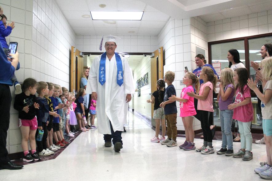H-BC senior Gus Jacobson leads the graduating seniors down the halls of the elementary school in the first graduation walk to claps of congratulations. This is the first Senior Walk and last the current elementary school. The new elementary school is slated to open this fall. Mavis Fodness/Rock County Star Herald Photo
