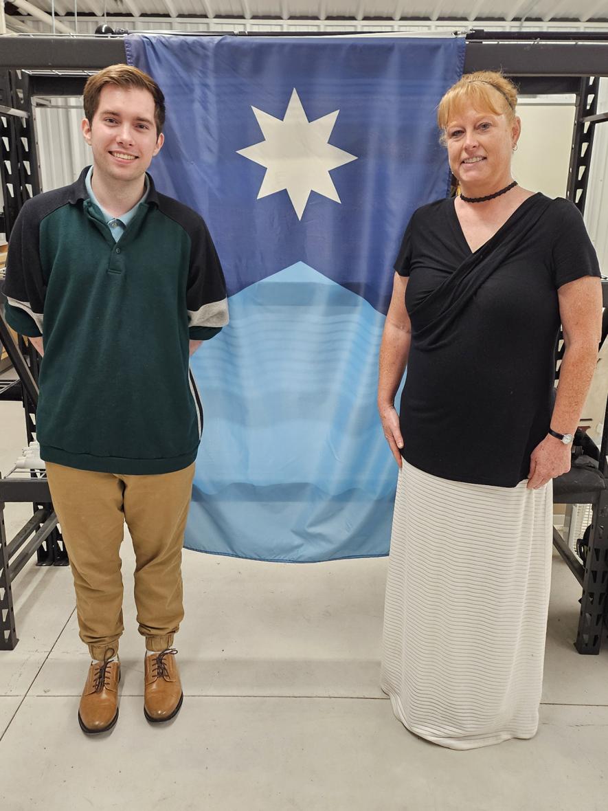 Anita Gaul (right), vice chair of the Minnesota State Emblems Redesign Commission, is pictured with Luverne’s Andrew Prekker who submitted the design that became the base of Minnesota’s new flag. They teamed up to present a program about the new state flag at the Rock County History Center in Luverne on Flag Day, Friday, June 14. Jason Berghorst/Rock County Star Herald Photo