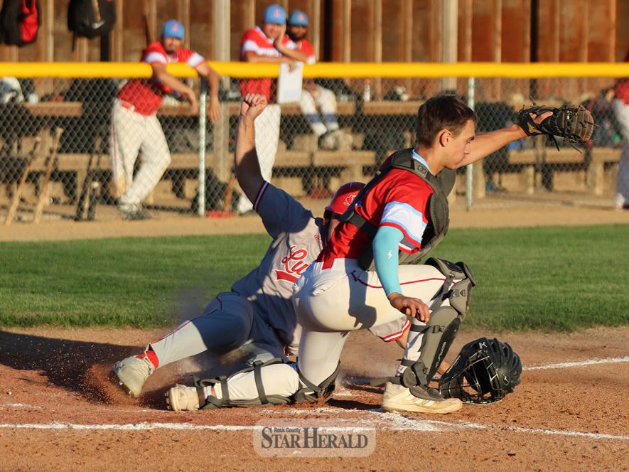 Redbirds player Casey Sehr slides into home plate during the game against Heron Lake Wednesday, June 26, in Worthington. Sehr was called out, but Luverne won the battle 4-0.