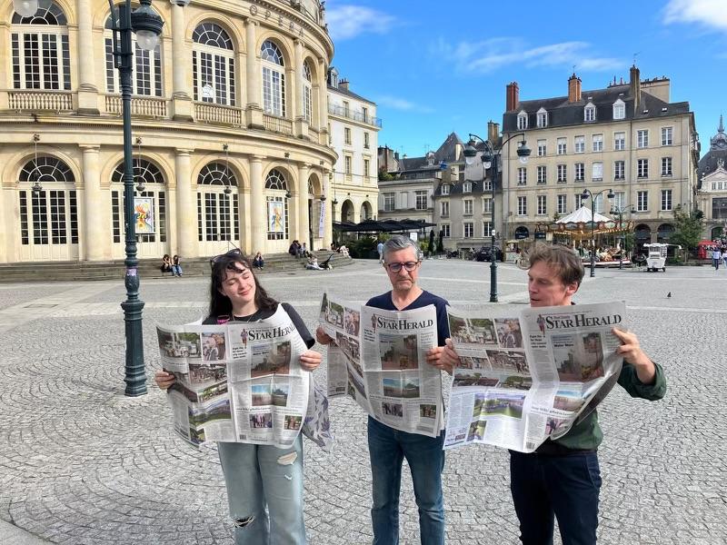 (From left) Emilie Rivalin, Patrick Rocher and Christophe Cocherie take a break recently in Rennes, France, to read about their project in the June 13th edition of Rock County Star Herald.  Submitted Photo
