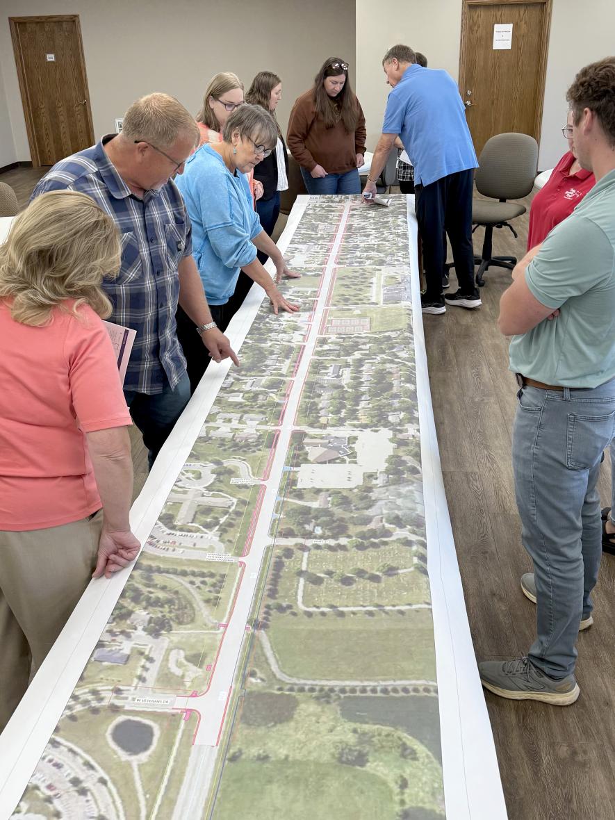 Attendees of the Aug. 28 meeting at the Trailhead building study an enlarged Highway 75 map showing details of construction stages. Lori Sorenson/Rock County Star Herald Photo