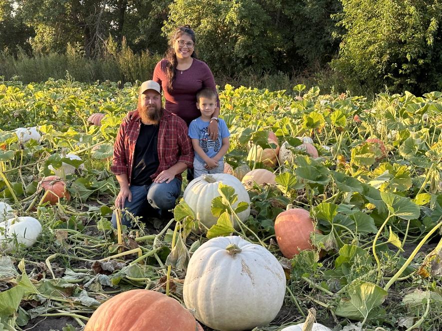 Pictured are owners Sean and Marcella McFarland and their son, Cedar. In the foreground are large white polar bear pumpkins. /Rock County Star Herald Photo/Lori Sorenson