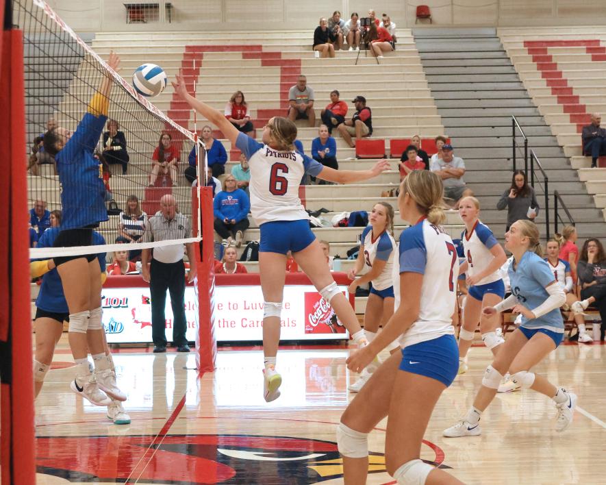 Sophomore Abbie Harris reaches to block a shot against Windom at the Luverne volleyball tournament Saturday, Sept. 9. H-BC lost two games to Windom in the tournament.