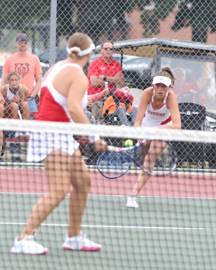 Junior Augusta Papik hustles to return a low shot in her doubles match Thursday, Sept. 7, in Luverne.
