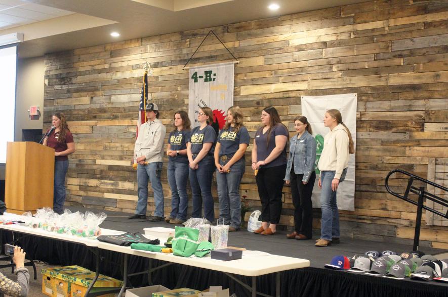 Rock County 4-H Extension Educator Fraya Webster (far left, at podium) installs the 2024-25 4-H Federation officers Saturday night during the annual awards and recognition ceremony at Grand Events in Luverne. Officers installed include (from left) Nathan Kinsinger, Andrea Luitjens, Brianna Kinsinger, Peyton Blom, Klarissa Burkman, Gabriella Porter and Nevaeh Lund. Mavis Fodness/Rock County Star Herald Photo