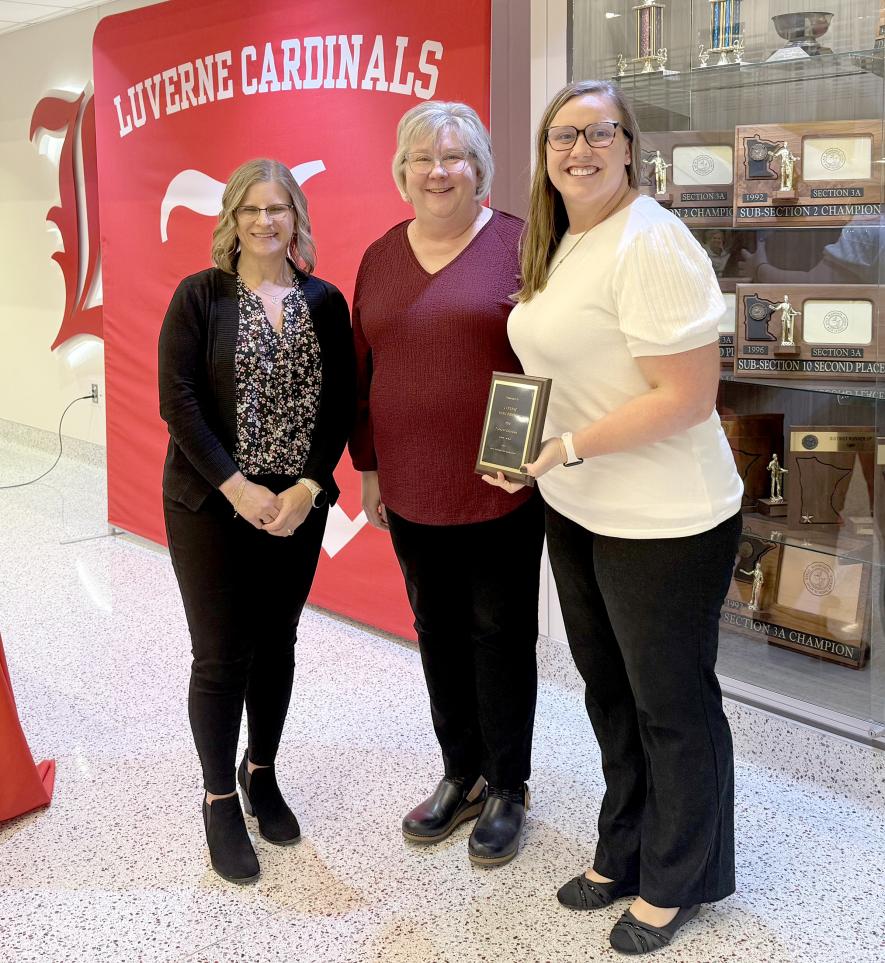 The Luverne Music Boosters Club was named the 2026 LEA Friend of Education during an American Education Week celebration Monday afternoon in the Luverne Middle School-High School Commons. Seana Graber (center) introduced the honorees, past president Heather Johnson (left) and current Music Boosters president Nicole Woodley. Lori Sorenson/Rock County Star Herald Photo