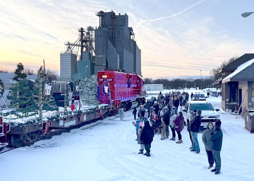 Families brave single-digit temperatures at the train depot to greet Santa and Mrs. Claus as they make their grand arrival on the Ellis & Eastern decorated train. Lori Sorenson/Rock County Star Herald Photo