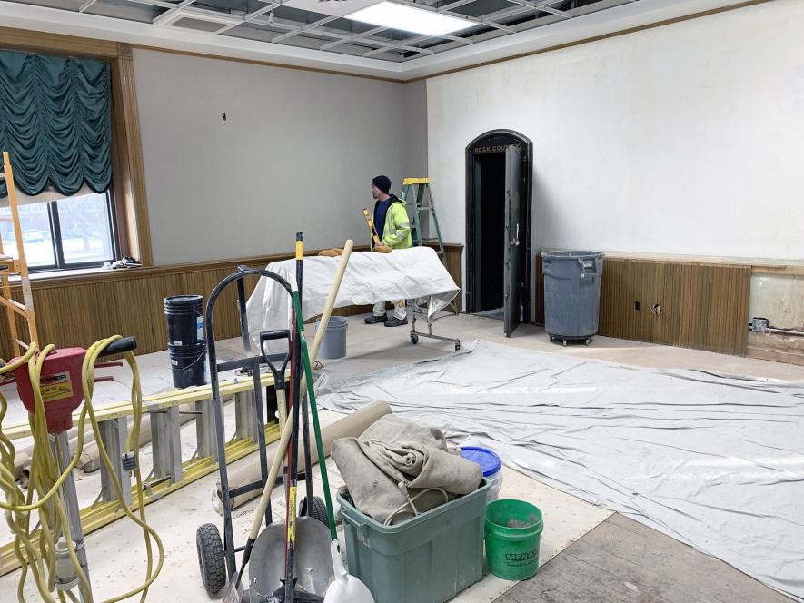 Subcontractor Zach Wilson with Wilson Painting uses a level on the wallpaper he hung Monday afternoon in the Land Records Office at the Rock County Courthouse in Luverne. The wallpaper matches that used in the recently completed renovation in the auditor-treasurer’s office. Mavis Fodness/Rock County Star Herald Photo