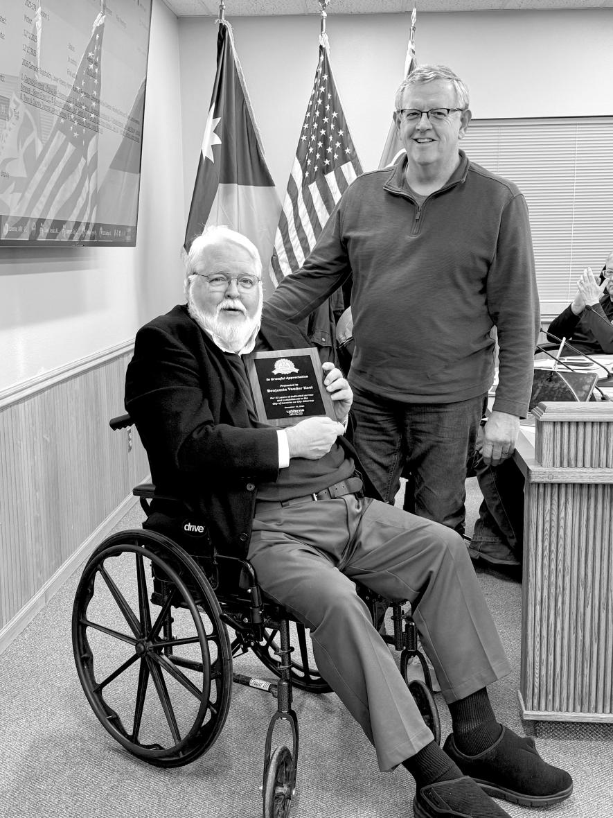 Luverne Mayor Pat Baustian (right) presents a plaque during the Dec. 18 council meeting to Ben Vander Kooi on behalf of the city thanking him for his 22 years as Luverne city attorney. Lori Sorenson/Rock County Star Herald Photo