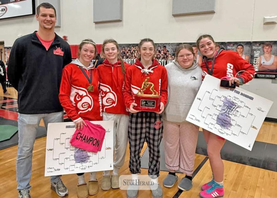 submitted photo/Belle2 The LHS girls’ wrestling team places third in the Belle of the Border Meet Saturday, Jan. 3, in St. James. Pictured from left are coach Jake Haugen, senior Bernie Rock, freshman Ellie Rock, seventh-grader Mary Rock, seventh-grader Gemma Zix and junior CeCe Rock stand with their trophy after the meet placing two first and two sixth place grapplers.