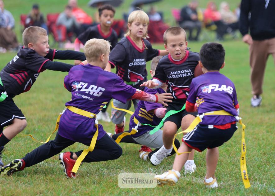 Bode Newgard carries the football looking for an opening in an FCA flag football game Saturday, Sept. 20, in Luverne. Both teams in the photo include first- and second-graders.