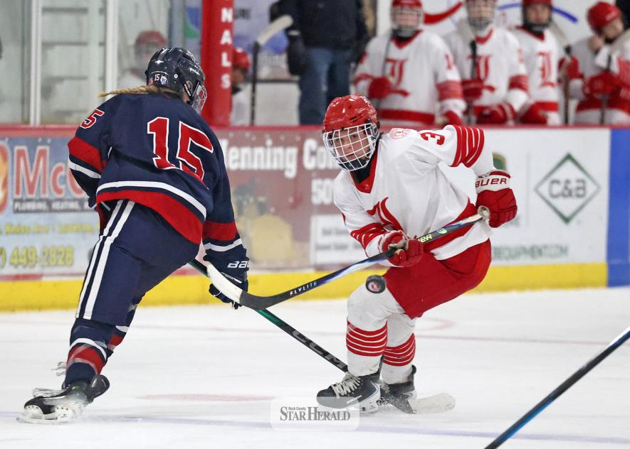 Greg Hoogeveen photo/GHOC3 Junior Tenley Behr eyes a bouncing puck in front of the Albert Lea Tigers net. The Cardinals outplayed Albert Lea to a 7-4 win at home Tuesday, Jan. 13