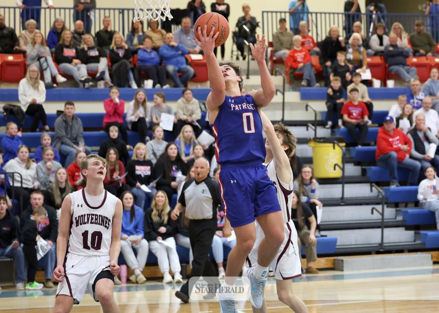 Greg Hoogeveen photo/HBCBBB2 Patriot senior Micah Bush leaves the ground to sink his 1,000th-career point. The Patriots beat Mountain Lake 90-31 in the home conference game Thursday, Jan. 29.
