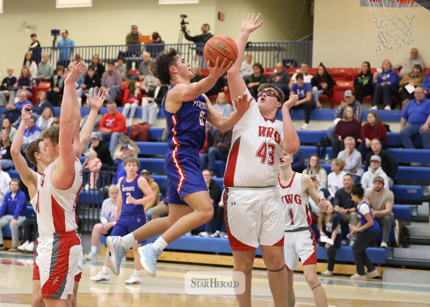 Greg Hoogeveen photo/HBCBBB3 H-BC senior Micah Bush switches hands mid-air for a basket against Westbrook Walnut Grove Thursday, Jan. 15, at home. The Patriots took down the Chargers 57-39 in the game.