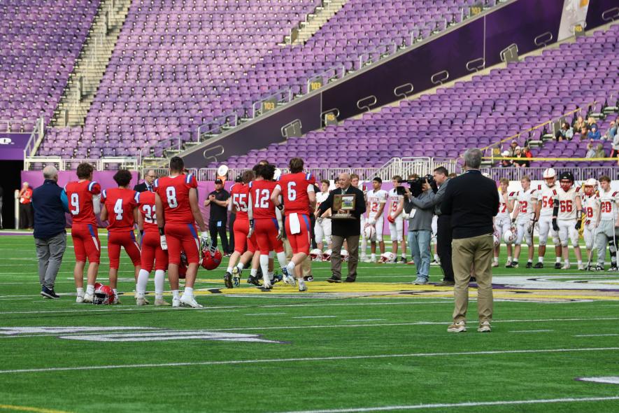 H-BC senior captains walk to centerfield to collect their 2025 nine-player State Championship victory after beating Hillcrest Lutheran Academy 46-22 Saturday, Nov. 22, in the U.S. Bank Stadium. Greg Hoogeveen/Rock County Star Herald Photo