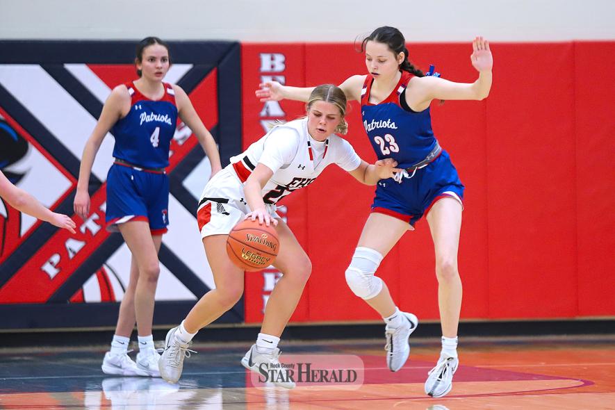 Patriot senior Emma Deelstra, No. 23., closely defends the basket against an Edgerton player Saturday, Jan. 18, at home.