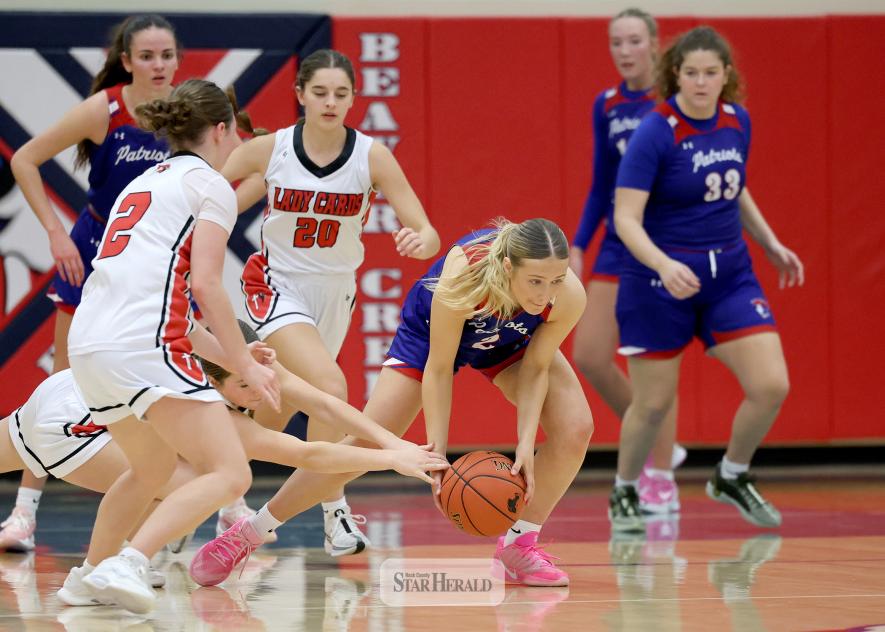 Greg Hoogeveen photo/HBCGBB3 H-BC junior Hailey Moser scoops up a loose ball against Dell Rapids in Hills Tuesday, Dec. 30. The Lady Pates beat the Cardinals 59-52 in the game.