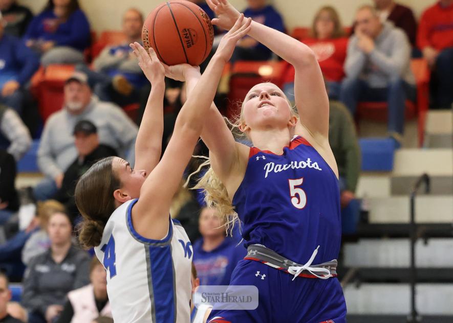 Greg Hoogeveen photo/HBCGBB1 H-BC junior Brynn Bakken reaches for a backet heavily guarded by a West Lyon player Monday, Jan. 26, at home. H-BC fell 62-48 in the game.
